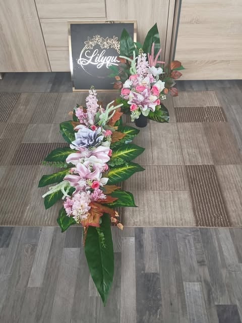 Elegant floral arrangement with pink and white flowers on dark wooden floor, with Llyna signage in background