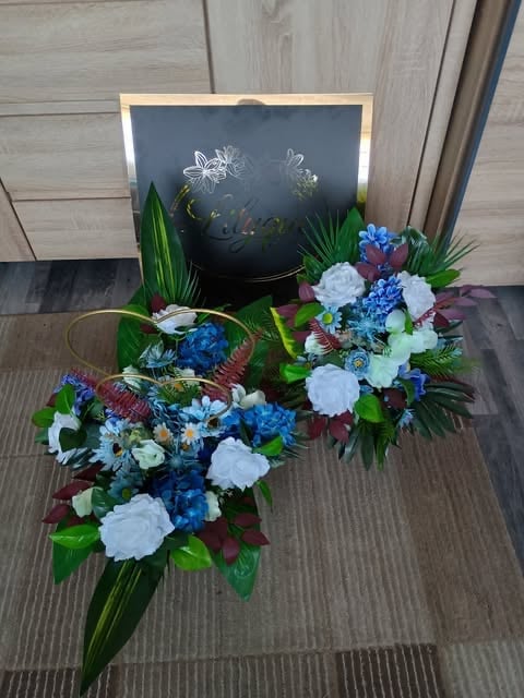 Two floral arrangements with white, blue, and purple flowers beside a chalkboard sign on wooden flooring