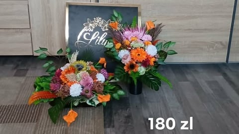 Two vibrant floral arrangements with mixed colorful flowers and greenery displayed next to a chalkboard sign, priced at 180 zl
