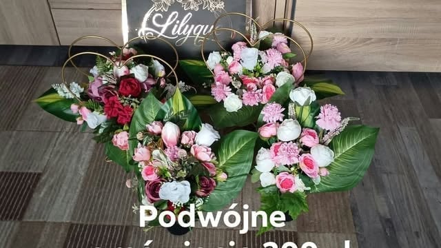 Two floral arrangements with pink, white, and red carnations displayed indoors with neon sign in background